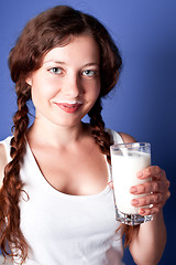 Image showing young woman enjoying a glass milk 
