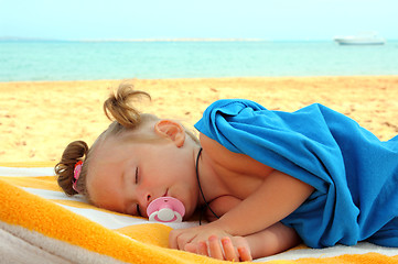 Image showing little girl sleeping on beach