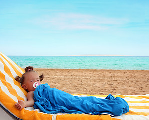 Image showing little girl sleeping on beach