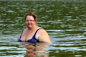 Image showing plump woman bath in river