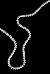 Image showing White pearls on the black silk