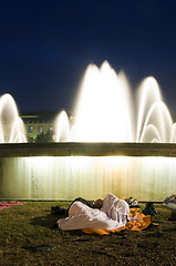 Image showing editorial couple sleeping by fountain at The Assembly protest Ca