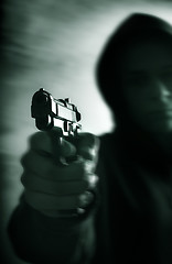 Image showing One young man with hand gun