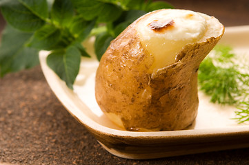 Image showing Baked potato with sour cream and fresh dill