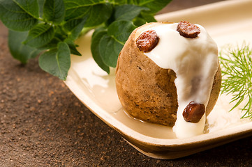 Image showing Baked potato with sour cream, greaves and fresh dill