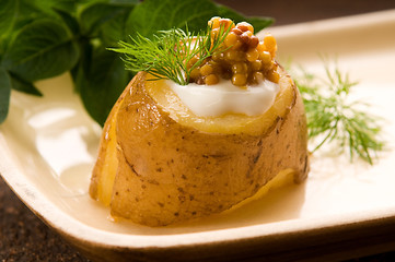 Image showing Baked potato with sour cream, grain Dijon mustard and herbs