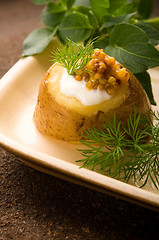 Image showing Baked potato with sour cream, grain Dijon mustard and herbs