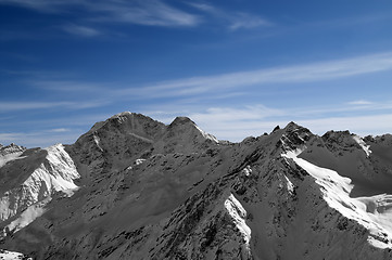 Image showing Black and white mountains against blue sky