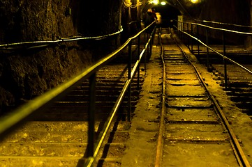 Image showing Railway in abandoned mine with yellow lights