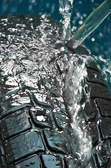 Image showing Washing tire on blue blurry background