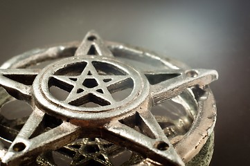 Image showing pentagram with reflection in the mirror an light 