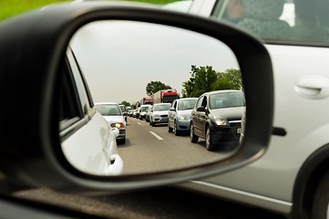 Image showing Traffic jam trough car mirror