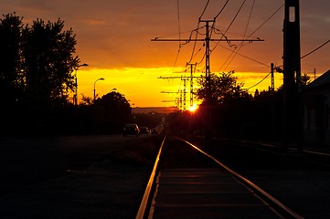 Image showing Sunset with traffic and rails in the suburbs