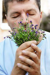 Image showing Man smelling lavender