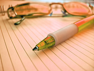 Image showing pencil and glasses in red