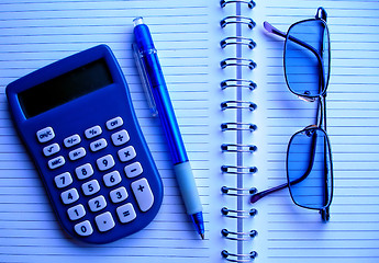 Image showing calculator, pencil and glasses