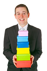 Image showing Young businessman with gift boxes