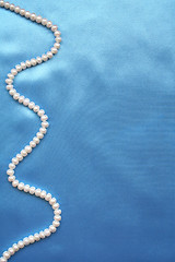 Image showing Pearls on the smooth elegant blue silk as background