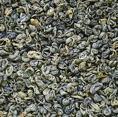 Image showing Dry green tea leaves as background