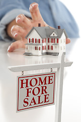 Image showing Real Estate Sign in Front of Woman Reaching for House