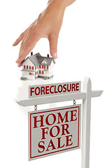 Image showing Womans Hand Choosing Home with Foreclosure Real Estate Sign