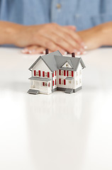Image showing Womans Folded Hands Behind Model House