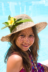Image showing Little girl wearing a hat near pool