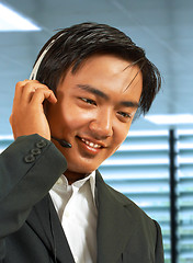 Image showing Male Sales Representative In His Office Talking On A Headset