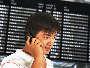 Image showing Man Talking On His Mobile Phone In An Airport