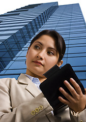 Image showing A Businesswoman Writing in a Personal Organizer