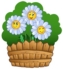 Image showing Three daisies with fence