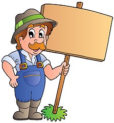 Image showing Cartoon farmer holding wooden board