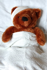 Image showing sick teddy with injury in bed