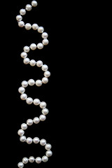 Image showing White pearls on a black silk