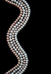 Image showing White, black and pink pearls on the black silk 