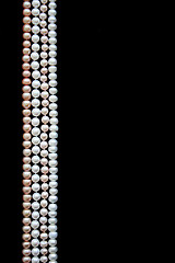 Image showing White and pink pearls on the black velvet 