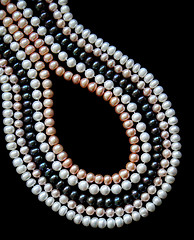 Image showing White, black and pink pearls on the black silk