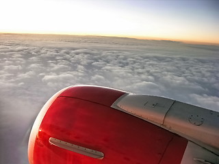 Image showing Airplane engine in sunset sky