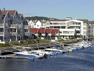 Image showing Nordic housing on a river with marina