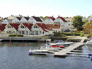 Image showing Little houses on a river