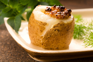 Image showing Baked potato with sour cream, grain Dijon mustard and herbs