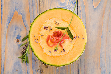 Image showing fresh melon soup with parma ham and lavender flower