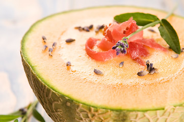 Image showing fresh melon soup with parma ham and lavender flower