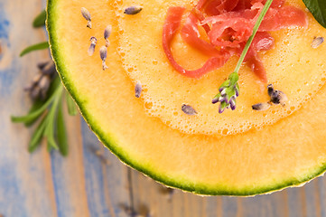 Image showing fresh melon soup with parma ham and lavender flower