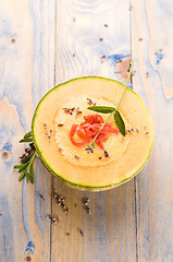 Image showing fresh melon soup with parma ham and lavender flower