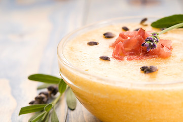 Image showing fresh melon soup with parma ham and lavender flower