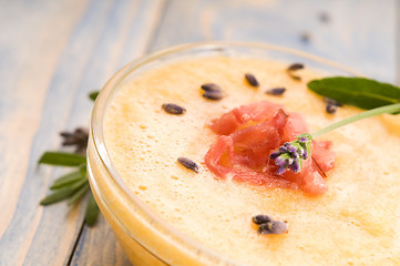 Image showing fresh melon soup with parma ham and lavender flower