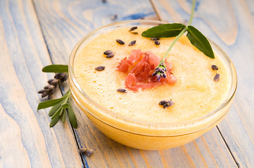 Image showing fresh melon soup with parma ham and lavender flower