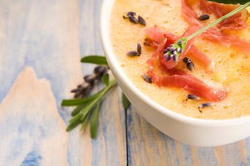 Image showing fresh melon soup with parma ham and lavender flower