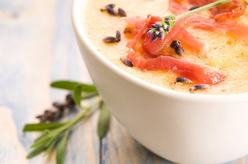 Image showing fresh melon soup with parma ham and lavender flower